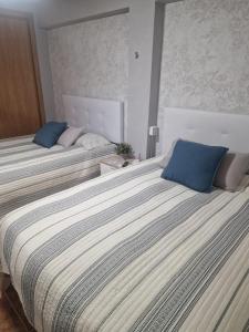 Postel nebo postele na pokoji v ubytování Habitaciones Zoe
