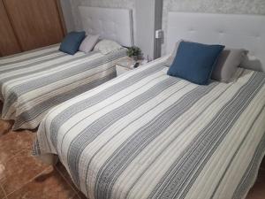 Postel nebo postele na pokoji v ubytování Habitaciones Zoe
