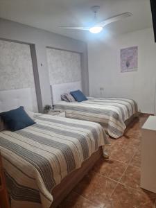 Postel nebo postele na pokoji v ubytování Habitaciones Zoe