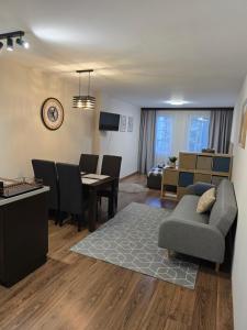 a living room with a couch and a dining room at IG Apartments Royal Towers 426 in Bansko