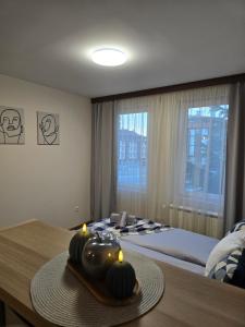 a bedroom with a bed and a table with candles on it at IG Apartments Royal Towers 426 in Bansko +10 photos