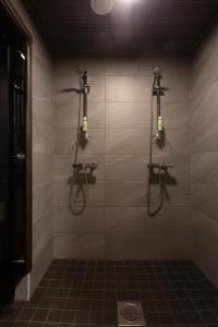 a bathroom with a shower with lights on the wall at Kajo Sky Lodge in Rovaniemi