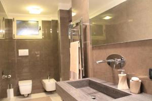 a bathroom with a sink and a toilet at Jane's Dream Apartment in San Felice del Benaco +5 photos