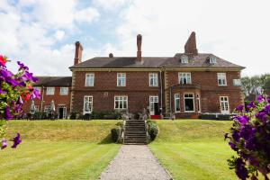a large brick house with a staircase in the yard at Albrighton Hall Hotel and Spa, a member of Radisson Individuals in Shrewsbury