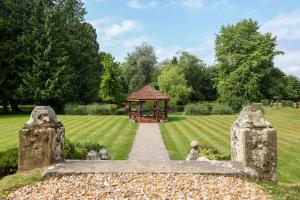 a gazebo in the middle of a garden at Albrighton Hall Hotel and Spa, a member of Radisson Individuals in Shrewsbury