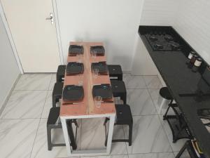 a long table with chairs and wine glasses on it at Guará Apart 3 in Guaratuba +24 photos