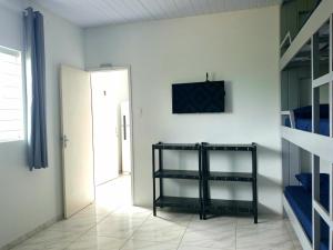 a room with a black shelf in a room with a door at Guará Apart 4 in Guaratuba