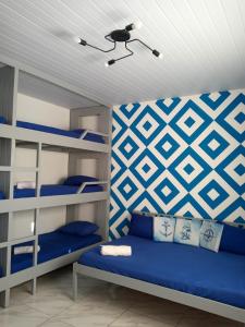 a bedroom with blue bunk beds and a ceiling at Guará Apart 4 in Guaratuba