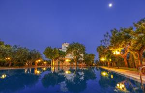 a swimming pool in front of a building at night at Villa Irlanda Grand Hotel in Gaeta