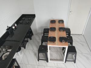 a group of tables and chairs in a room at Guará Apart 4 in Guaratuba