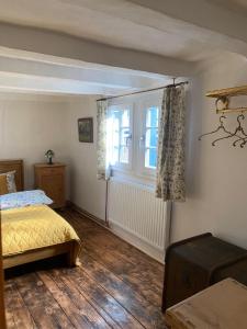 a bedroom with a bed and a window at Rosige Zeiten, Ferien im Fachwerkhof in Mechernich