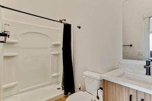 a bathroom with a toilet and a sink and a mirror at 3 Min to DT 2 Car Garage Lux Townhome King Bed in Salt Lake City +21 photos