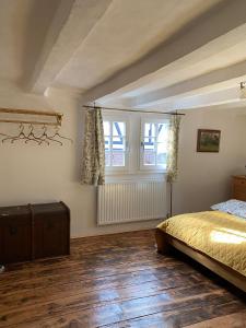 a bedroom with a bed and a window at Rosige Zeiten, Ferien im Fachwerkhof in Mechernich +34 photos