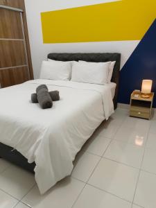 a bedroom with a bed with two stuffed animals on it at Family Deluxe 2 BR by KLIA Airport Homestay in Sepang
