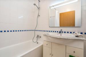 a bathroom with a sink and a mirror and a tub at Cool Motion Rocha Beach T2 in Portimão +13 photos