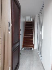 a hallway with a staircase with a door and a stair case at Place of Grace in Cape Town