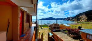 a view of the ocean from a balcony of a building at Willka Uta in Comunidad Challapampa
