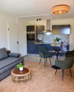 a living room with a couch and a table at Hotel Sonnengarten Apartments in Überlingen