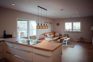 a kitchen and living room with a couch and a table at Ferienhaus Eifeltoni in Nettersheim