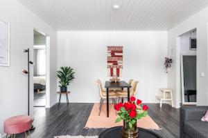 a living room with a table and chairs at Cozy 1BR Apartment next to the Beach with Free Parking in Lahti