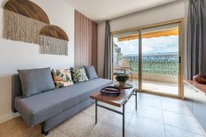 a living room with a couch and a table at Salou Luxury Stay Beach Pool Parking AC in Salou