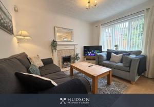 a living room with a couch and a table at 3 Bedroom House with Garden in Admaston