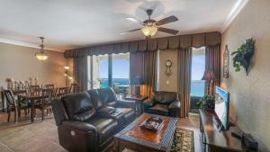 a living room with a couch and a ceiling fan at Beach Club Gulf Front 3B Condo - 1003 in Pensacola Beach