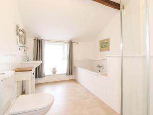 a bathroom with a toilet and a sink and a tub at Middletown in Keswick +31 photos
