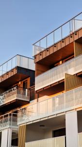 an apartment building with balconies on the side of it at POSESJA APARTAMENTY & SPA - Posesja Plażowa 4a I in Grzybowo