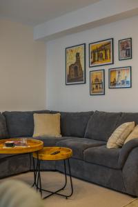 a living room with a couch and a table at Alvera Apartament in Alba Iulia
