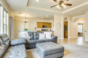 a living room with a couch and a ceiling fan at Home with Game Room Near Zion National Park! in Hurricane