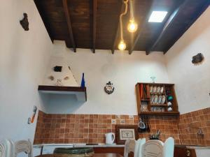 a kitchen with a counter and chairs in a room at Casita Sofia in Caleta de Sebo
