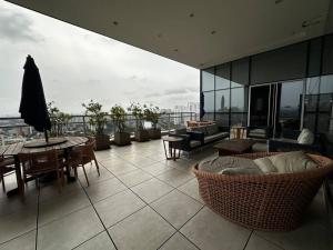 a balcony with a table and chairs on a building at The CittyPlex Experience in Osasco
