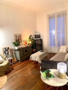 a living room with a couch and a table at Full house Canal Saint-Martin in Paris