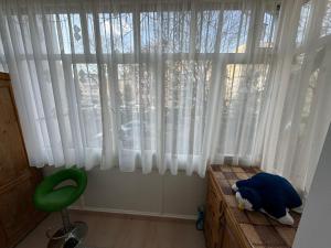 a room with a window with a teddy bear sitting on a dresser at Perfect for a family! in Luduş +1 photo