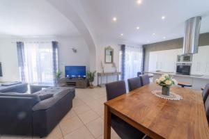 ein Wohnzimmer mit Sofa und Tisch in der Unterkunft Aillan Hervé Villa piscine chauffée et son spa in Saint-Maurice-sur-Eygues