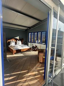 una camera con un letto e una porta a vetri di muchhome LUXURY APARTMENTS - MuchLoft - Vintage Loft in Bad Tölz mit Freizeitlounge a Bad Tölz