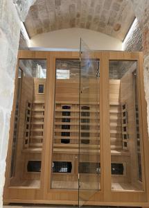a wooden cabinet with glass doors in a room at PETRA ANTIQUA in Locorotondo