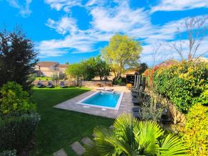 a backyard with a swimming pool and landscaping at Rooms and Apartments IstraSoley in Bale