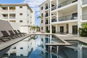 a swimming pool in front of a building at Bonaire Beach Apartment 12 with communal pool and diving facilities in Kralendijk