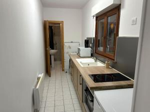 a kitchen with a sink and a counter top at Lure centre in Lure