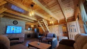a living room with a couch and a tv in a house at Hill Escape in Mokro