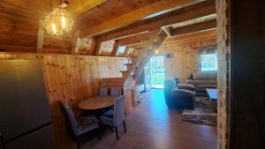 a living room with a staircase in a wooden house at Hill Escape in Mokro
