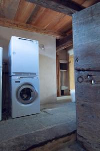 a washer and dryer sitting in a room at Antica Casa Rivoira Ciliegio in Masera