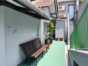 a bench sitting on the side of a building at Pousada da Cia in Blumenau
