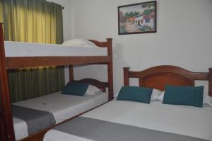 a bedroom with two bunk beds and a picture on the wall at Hotel San Rafael in Sincelejo