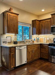 a kitchen with wooden cabinets and a sink at Family get away Near Sly Park Lake & Apple Hill in Pollock Pines