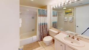a bathroom with a toilet and a tub and a sink at Getaway to the Beach 2 Bdrm Villa with Amenities in Pawleys Island +8 photos