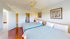 a bedroom with two beds and a ceiling fan at Getaway to the Beach 2 Bdrm Villa with Amenities in Pawleys Island