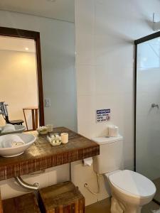 a bathroom with a toilet and a sink and a mirror at Pousada Villa Tiradentes Suítes - Centro in Tiradentes +78 photos